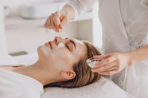Esthetician applying face mask